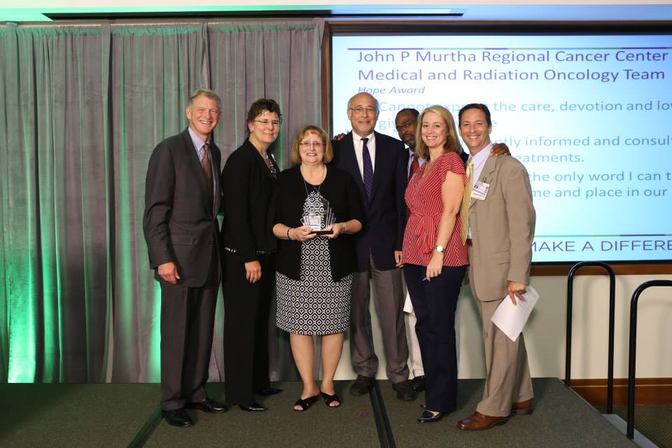 Peter G. Ellis, M.D., deputy director of Clinical Services, UPMC CancerCenter and Stephanie K. Dutton, Chief Operating Officer, UPMC CancerCenter, present the Hope Award to the John F. Murtha Regional Cancer Center Medical and Radiation Oncology Team.
