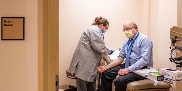 Dr. David Nace gives blood to receive a COVID-19 antibody test.