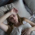 Menopausal Mature Woman Suffering With Insomnia In Bed At Home