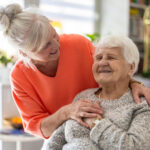 Female home caregiver providing emotional support to an elderly woman